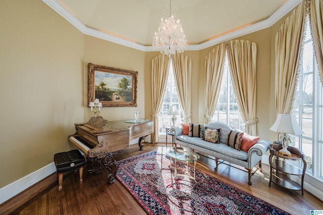 living area featuring crown molding, hardwood / wood-style flooring, and a chandelier