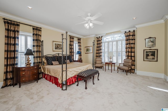 carpeted bedroom featuring ceiling fan and crown molding