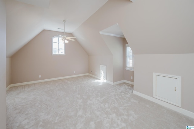 bonus room featuring plenty of natural light, light carpet, and lofted ceiling