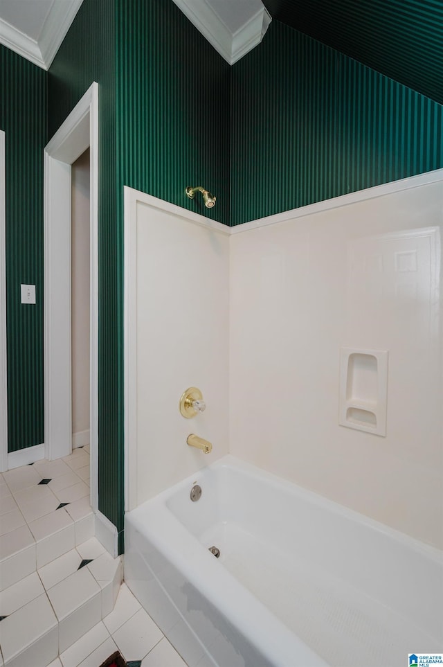 bathroom with a bathing tub, ornamental molding, and tile patterned flooring