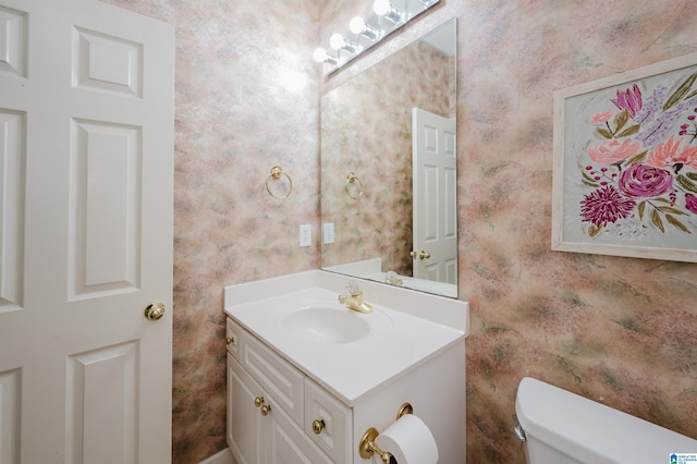 bathroom featuring toilet and vanity