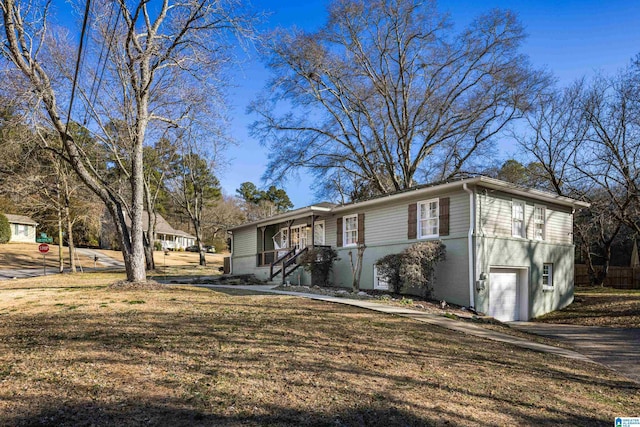 view of front of home with a garage and a front lawn