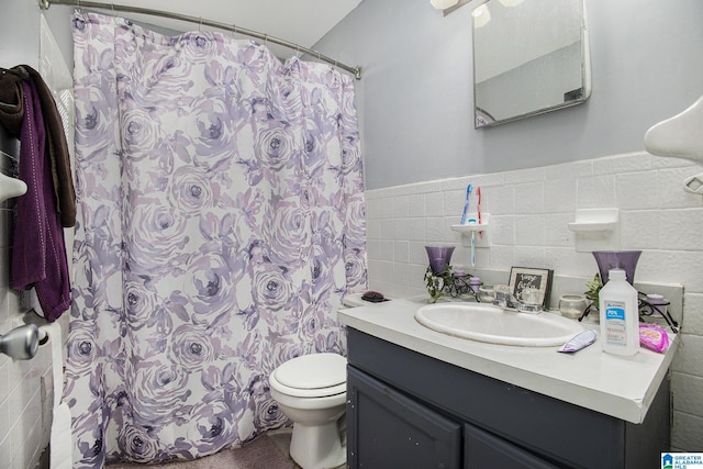 bathroom featuring tile walls, toilet, vanity, and a shower with curtain