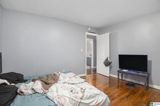 bedroom with dark wood-type flooring