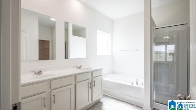 bathroom featuring vanity and independent shower and bath