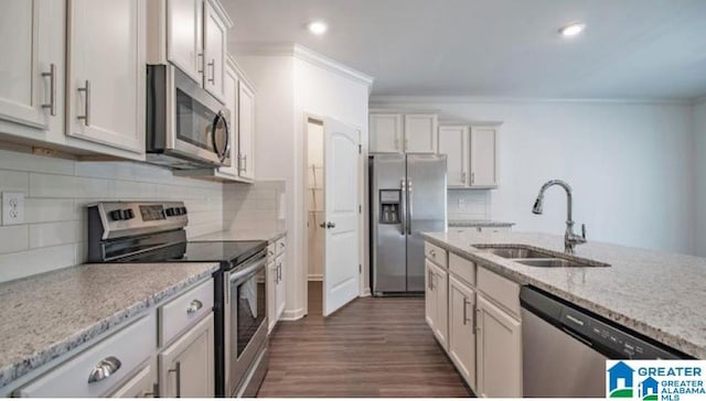 kitchen featuring light stone countertops, sink, white cabinets, and stainless steel appliances