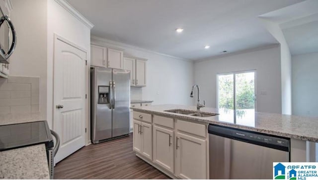 kitchen featuring light stone countertops, white cabinets, stainless steel appliances, sink, and crown molding