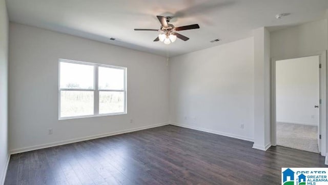 empty room featuring ceiling fan and dark wood-type flooring