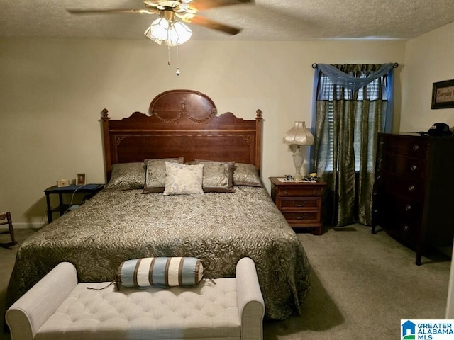 bedroom with ceiling fan, a textured ceiling, and carpet flooring