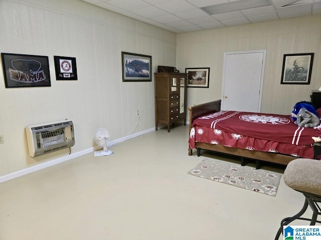 bedroom with heating unit and concrete floors