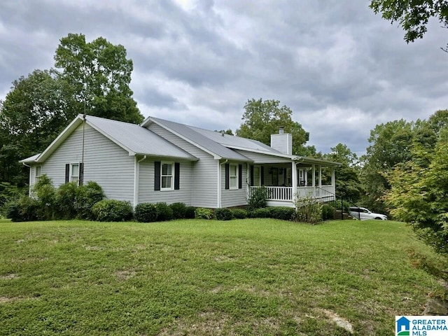 exterior space featuring a porch and a lawn