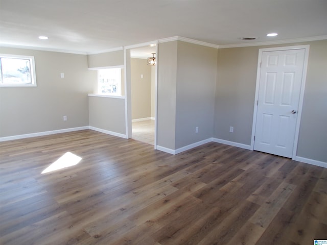 empty room featuring dark hardwood / wood-style floors and crown molding