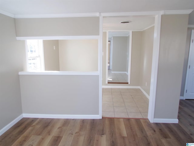 corridor with hardwood / wood-style flooring and crown molding