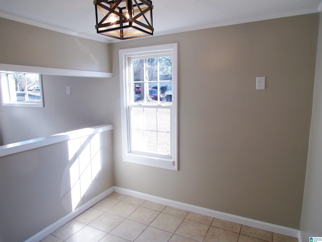 unfurnished dining area with ornamental molding and light tile patterned flooring