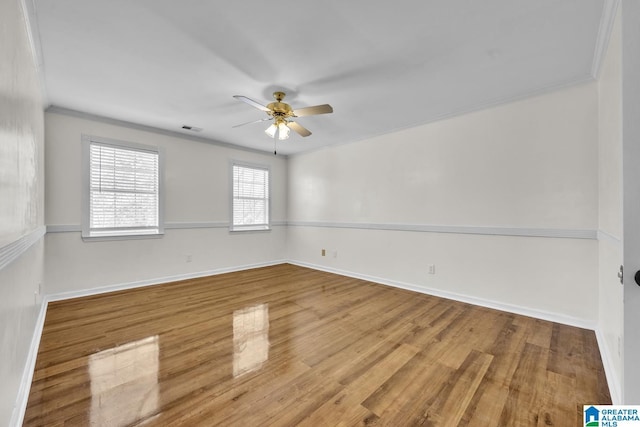 unfurnished room featuring ceiling fan, wood-type flooring, and crown molding