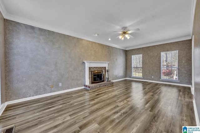 unfurnished living room with a fireplace, ornamental molding, and hardwood / wood-style floors