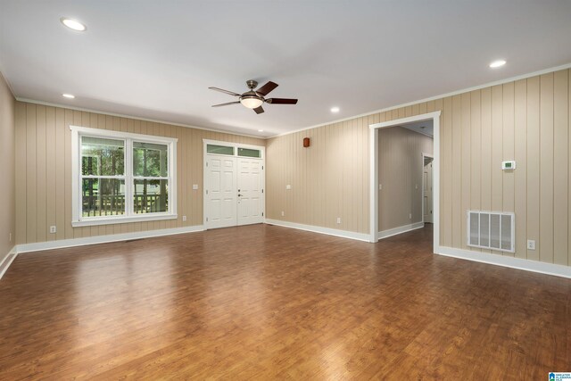 unfurnished room with ceiling fan, dark hardwood / wood-style flooring, and ornamental molding