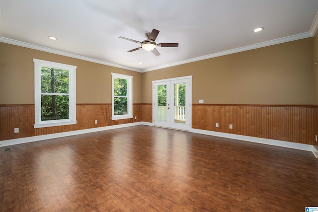 unfurnished room featuring ceiling fan, dark hardwood / wood-style flooring, crown molding, and french doors