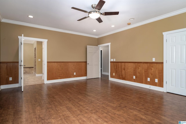 unfurnished room featuring ceiling fan, crown molding, and dark hardwood / wood-style floors