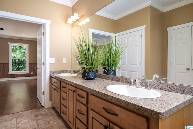 bathroom featuring ornamental molding and vanity