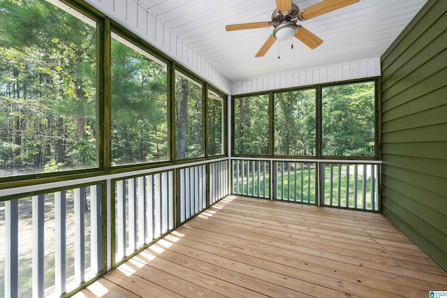 unfurnished sunroom featuring ceiling fan