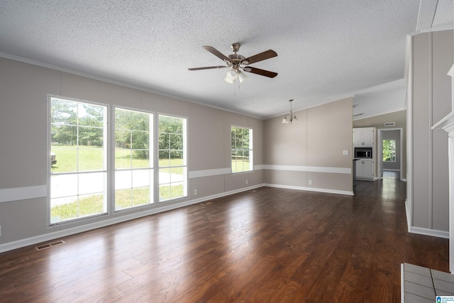 spare room with ceiling fan, a textured ceiling, dark hardwood / wood-style floors, and lofted ceiling