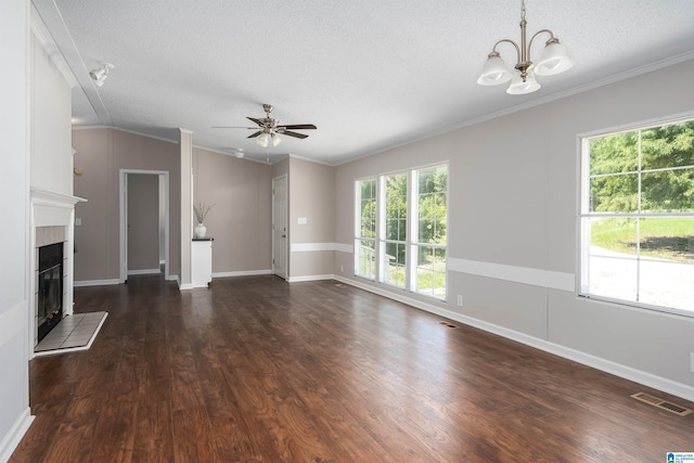 unfurnished living room with dark wood-type flooring, ornamental molding, and a tiled fireplace