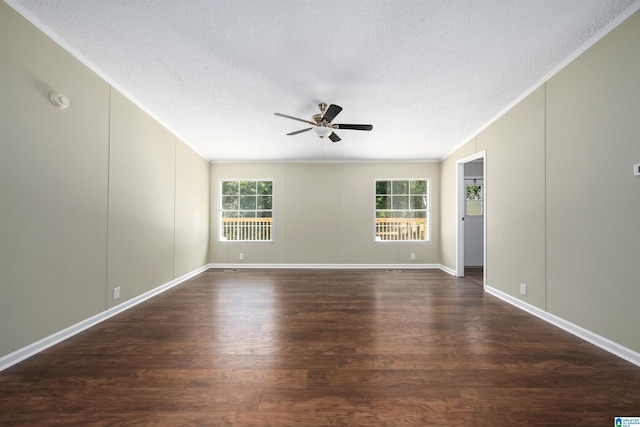 spare room with ceiling fan, dark wood-type flooring, a textured ceiling, and crown molding