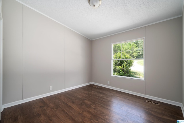 unfurnished room featuring dark wood-type flooring, ornamental molding, and a textured ceiling