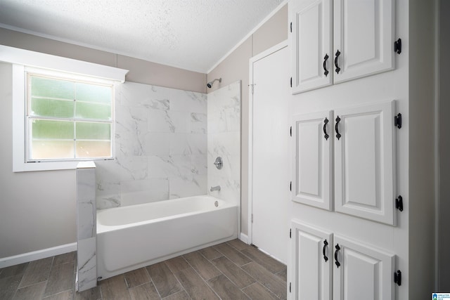 bathroom with shower / bathtub combination and a textured ceiling