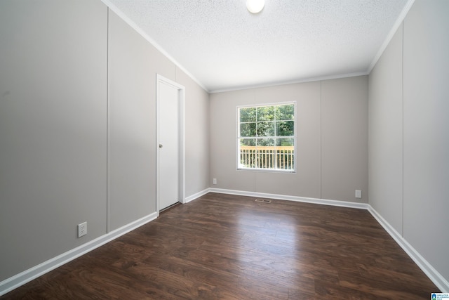 empty room with dark wood-type flooring, ornamental molding, and a textured ceiling