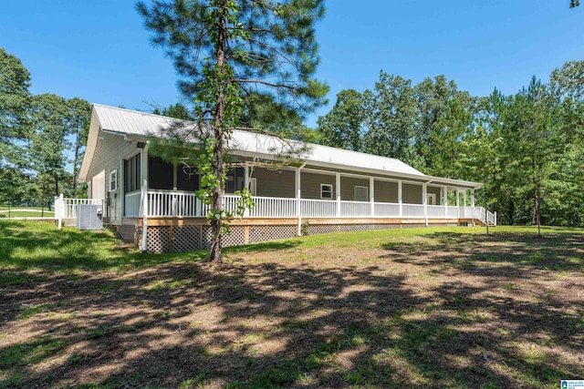 exterior space featuring a porch and a yard