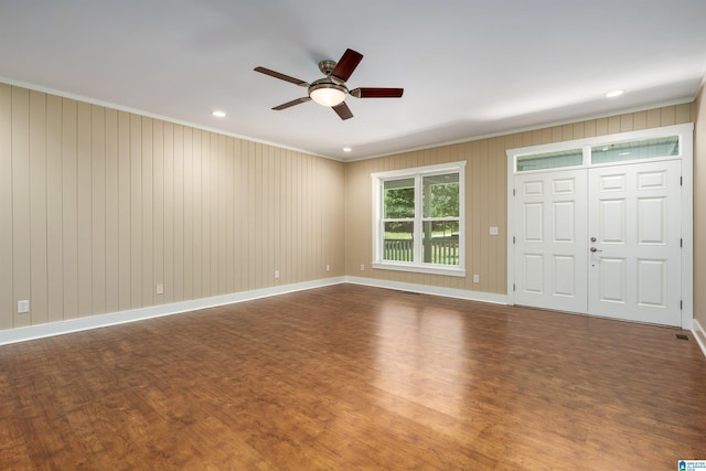 unfurnished bedroom featuring ceiling fan, wood-type flooring, a closet, and ornamental molding