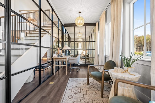 sitting room featuring an inviting chandelier and hardwood / wood-style flooring