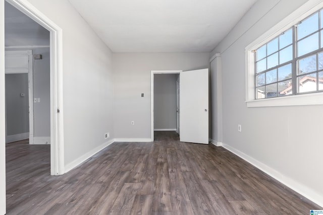 unfurnished bedroom with dark hardwood / wood-style floors