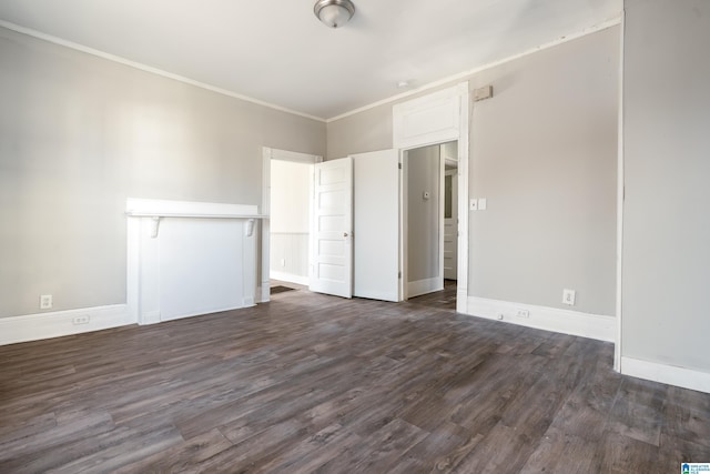 unfurnished bedroom with dark wood-type flooring and crown molding