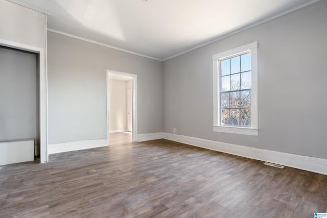 unfurnished bedroom featuring dark hardwood / wood-style flooring and crown molding