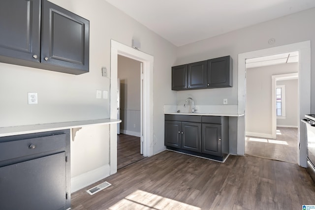 kitchen featuring dark wood-type flooring, sink, and white electric range