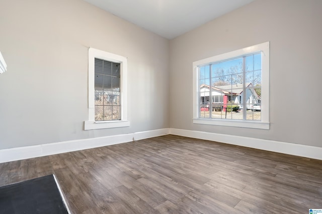 unfurnished room featuring dark hardwood / wood-style flooring