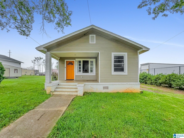 bungalow-style home featuring a front yard