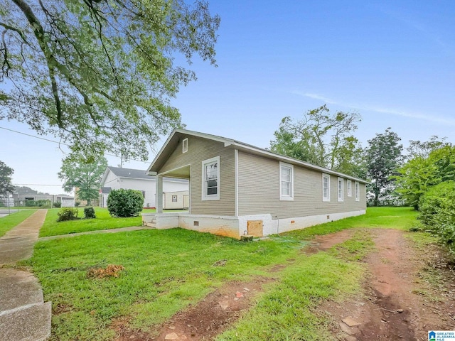 view of property exterior with a yard