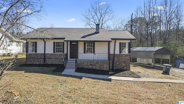 view of front facade with a front lawn, a carport, and a porch