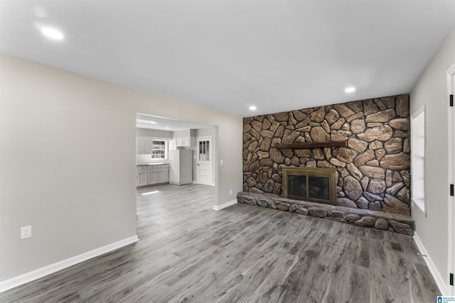 unfurnished living room featuring a fireplace and hardwood / wood-style flooring