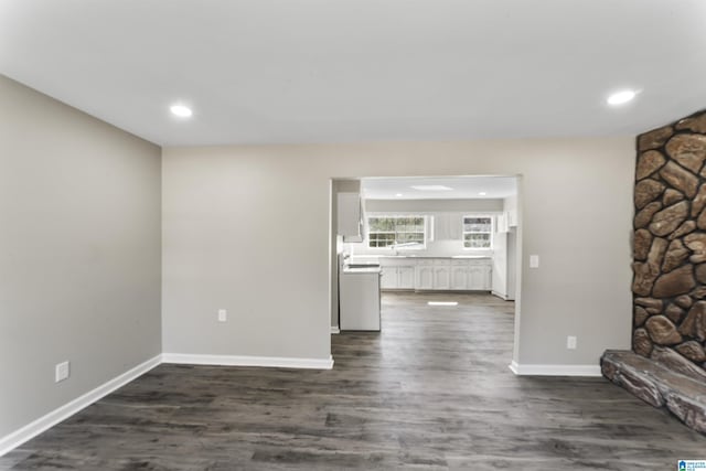 unfurnished living room with dark wood-type flooring