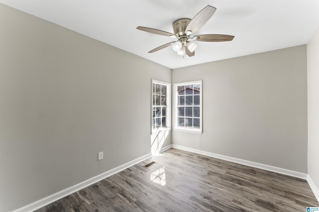 empty room featuring ceiling fan and dark hardwood / wood-style floors