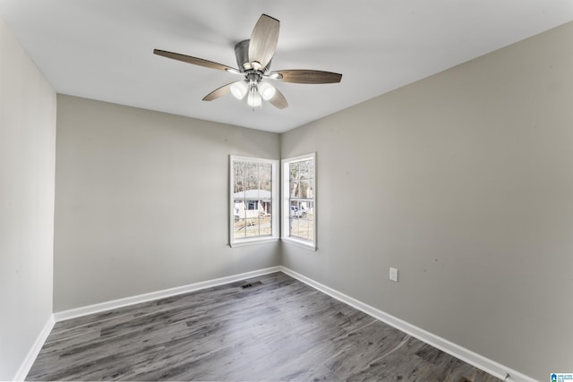 empty room featuring ceiling fan and dark hardwood / wood-style flooring