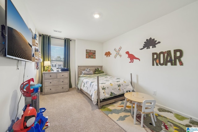 bedroom with light colored carpet