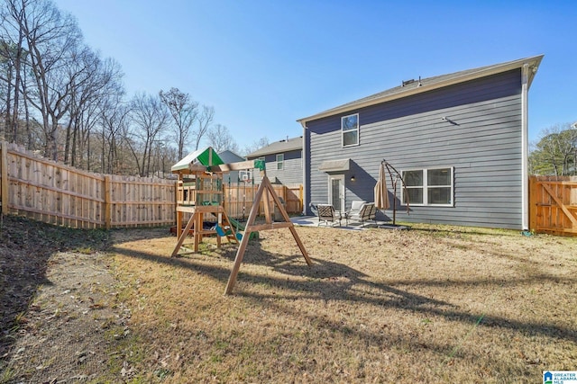 back of property featuring a patio, a playground, and a yard