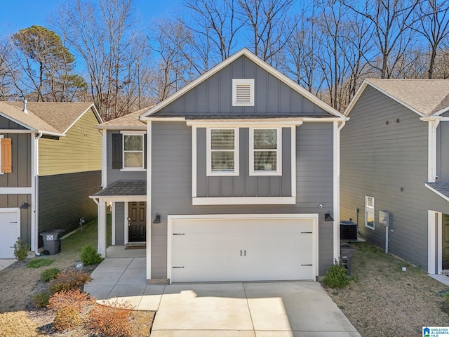 view of front of home featuring central AC unit and a garage