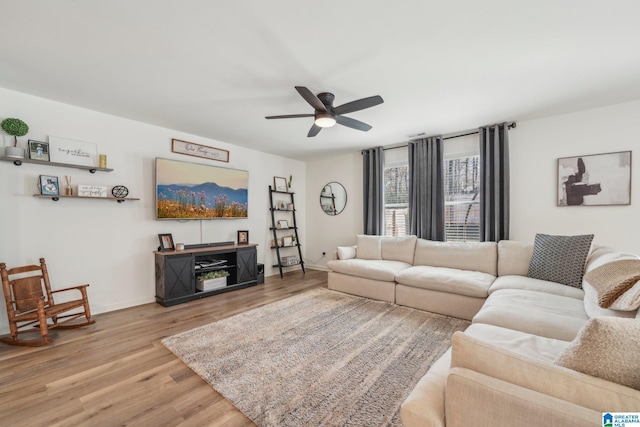 living room with ceiling fan and light hardwood / wood-style flooring